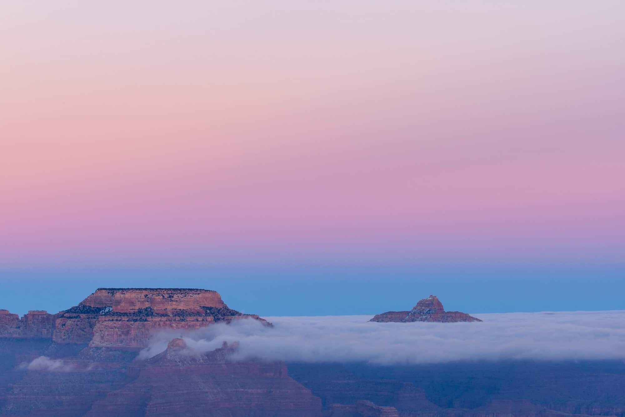 the grand canyon socked in after sunset led to an incredible photo of the peaks almost floating above the cloud cover