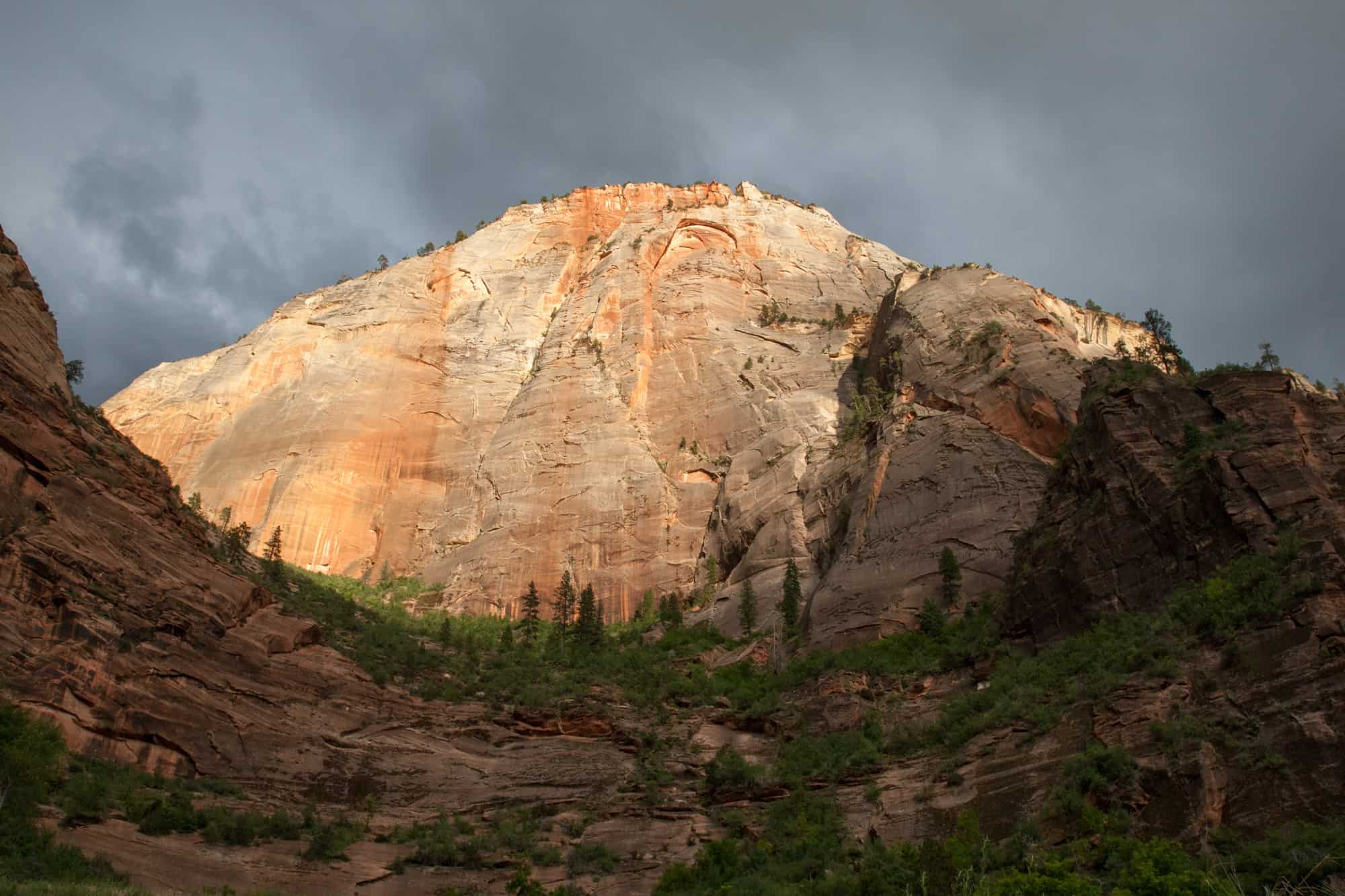 sunset leaves a glow on a white mountain in zion national park, one of the national parks near st. george, utah