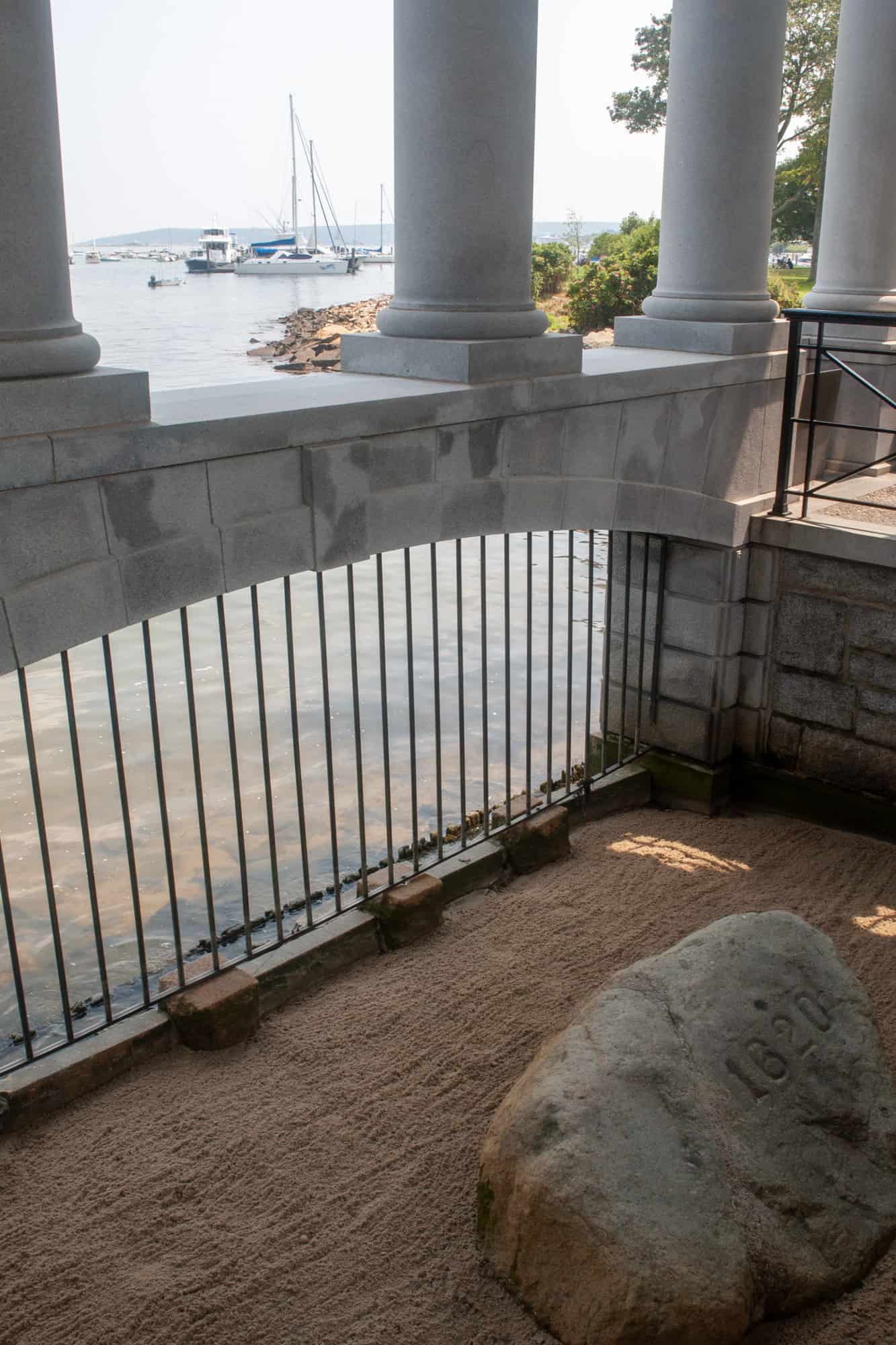 on a day trip to plymouth you have to stop by plymouth rock, seen under the granite canopy along the water's edge