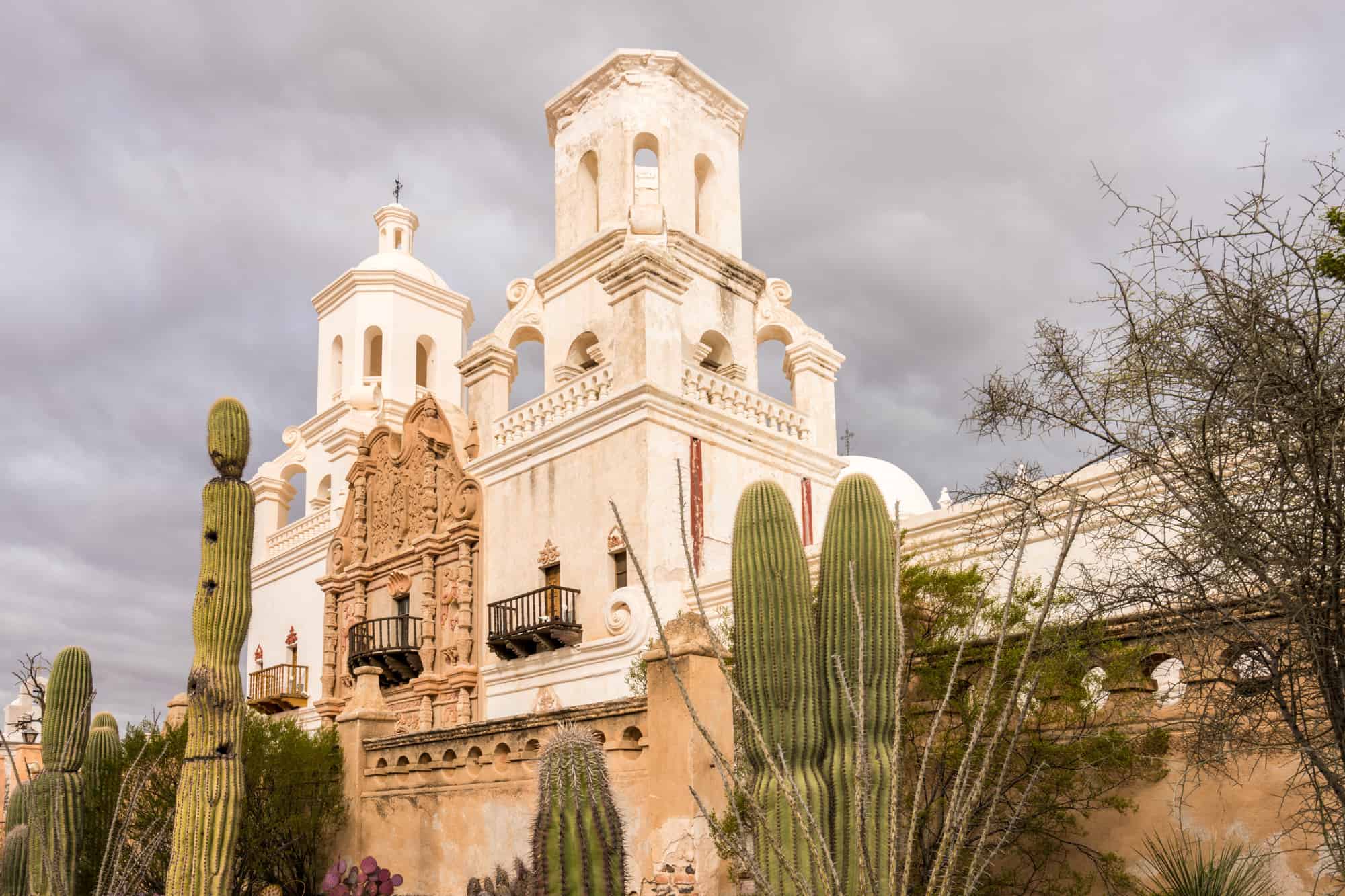 mission san xavier del bac from a slight angle and shot low so it appears large and fills the frame with dark clouds