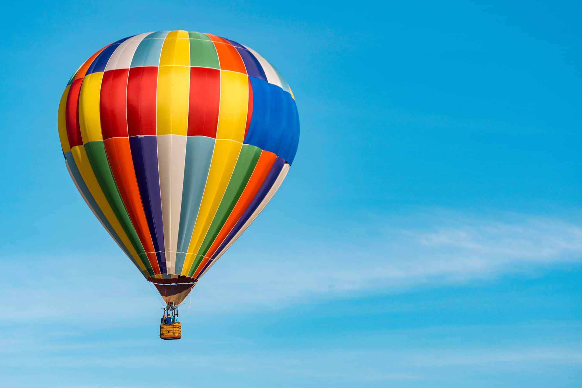 a colorful hot air balloon against a blue sky