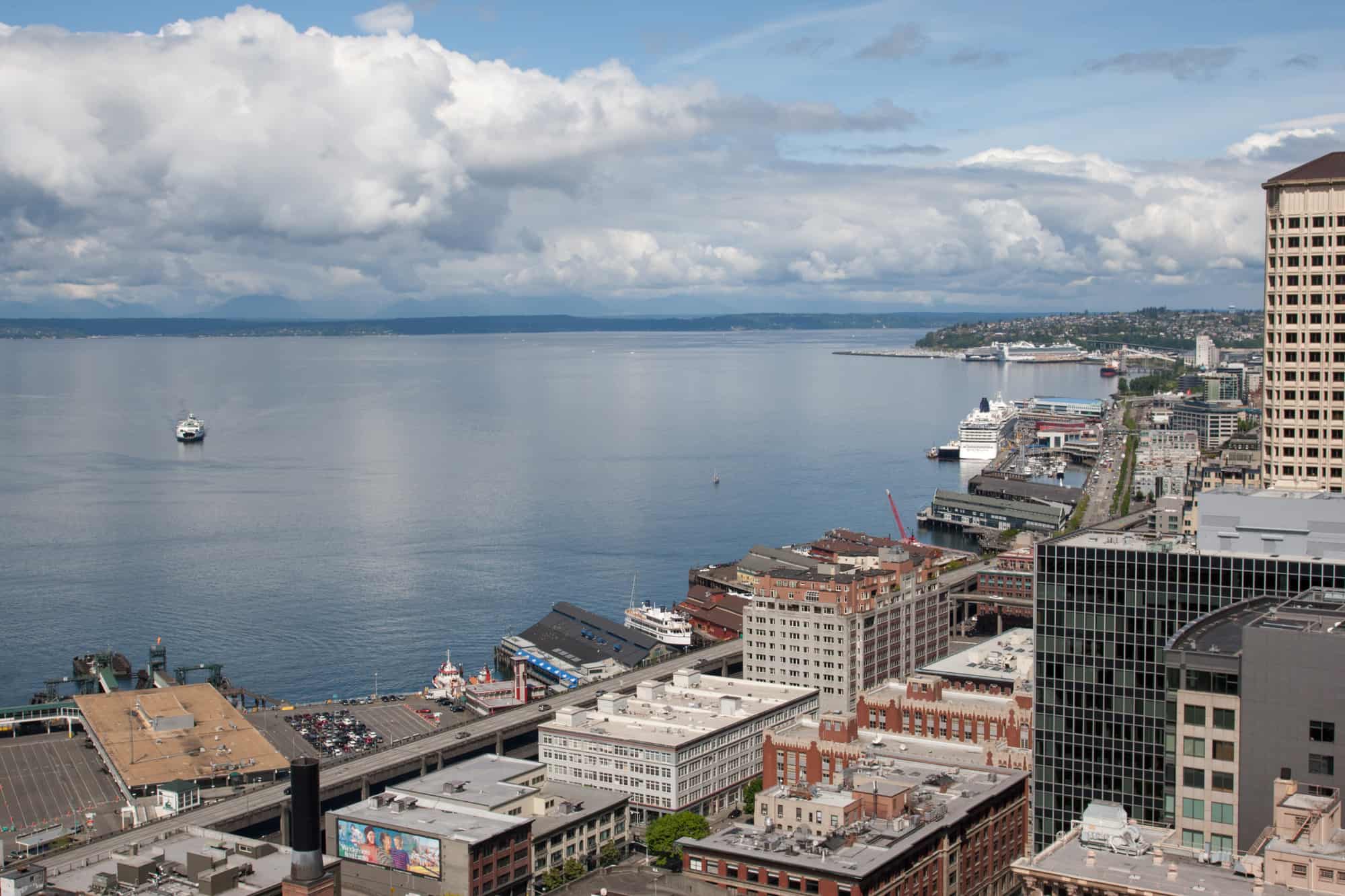view of puget sound with the ferry out in the water and the buildings along the shore