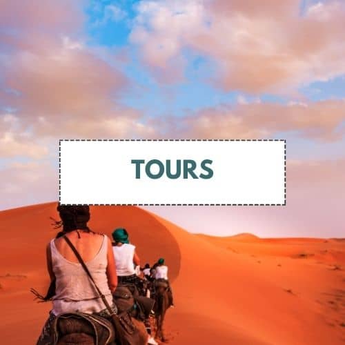 tours box with title and people on horseback riding in red sand dunes