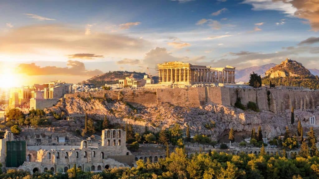 A landscape photo of Athens Greece at sunrise with beautiful light shining on the ruins