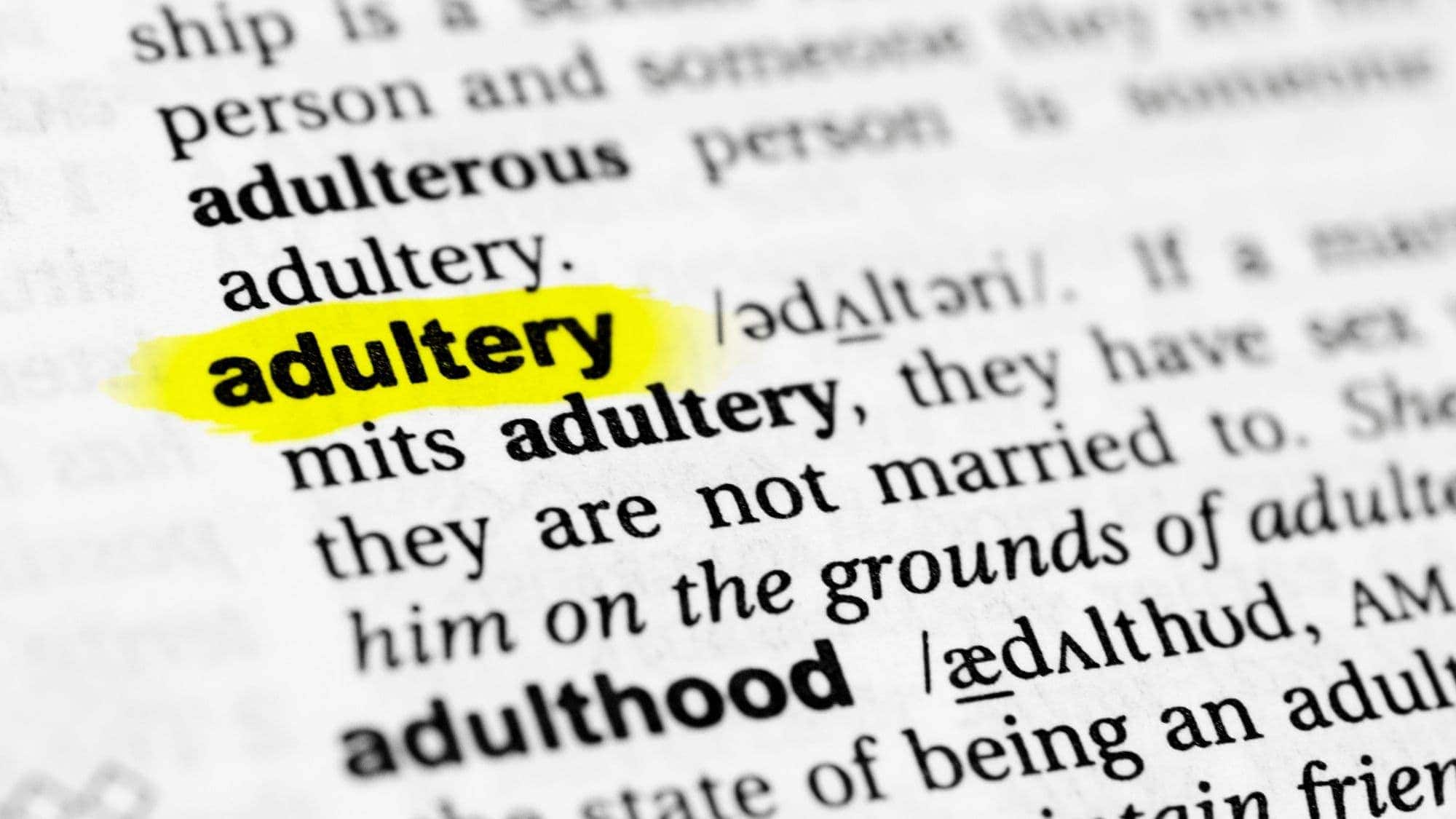A close-up of a dictionary entry for the word "adultery," with the word highlighted in bright yellow.