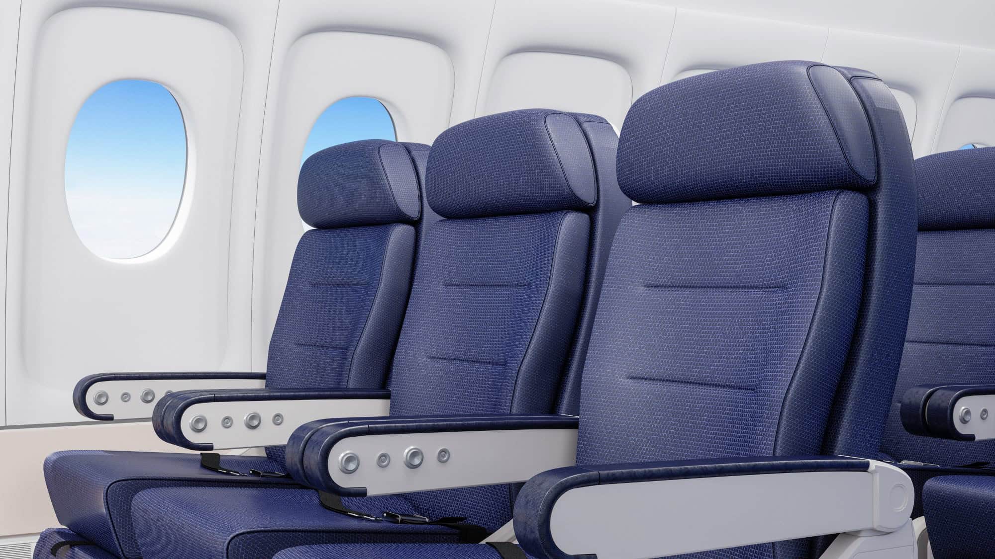 Three sleek, navy blue airplane seats with adjustable headrests line up next to bright windows in a modern cabin.