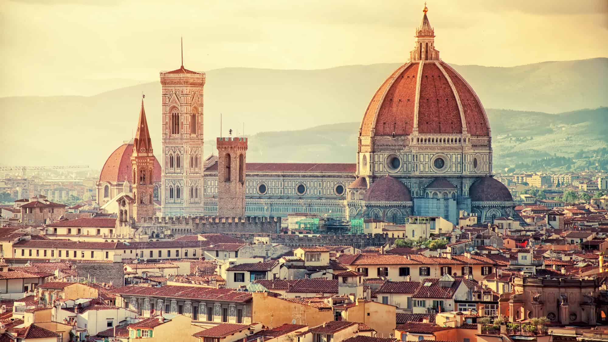 The iconic red dome of Florence’s Duomo rises above the city’s terracotta rooftops.