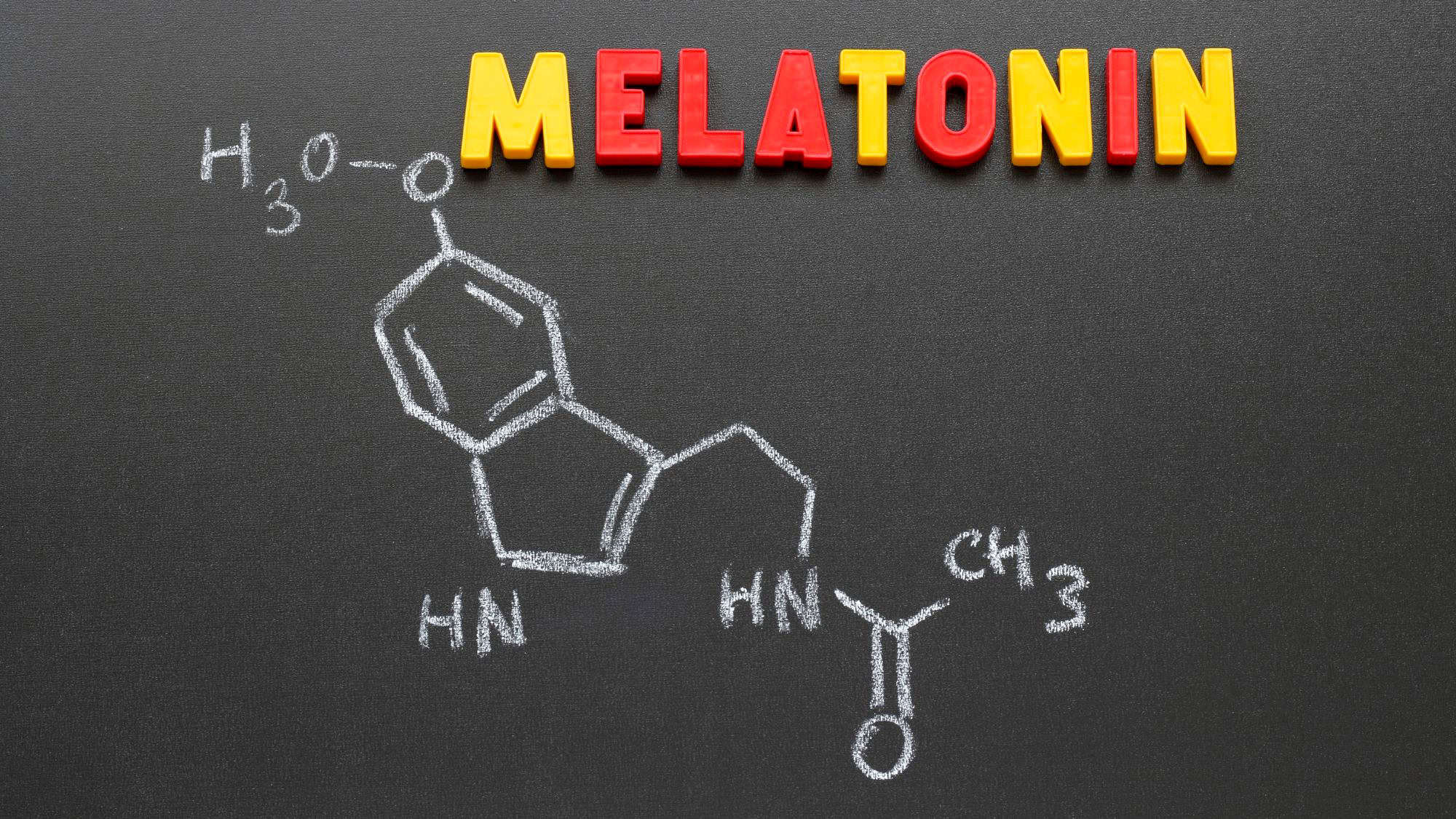 The word “MELATONIN” in colorful block letters above a chalkboard drawing of its chemical structure, highlighting the sleep-regulating hormone.