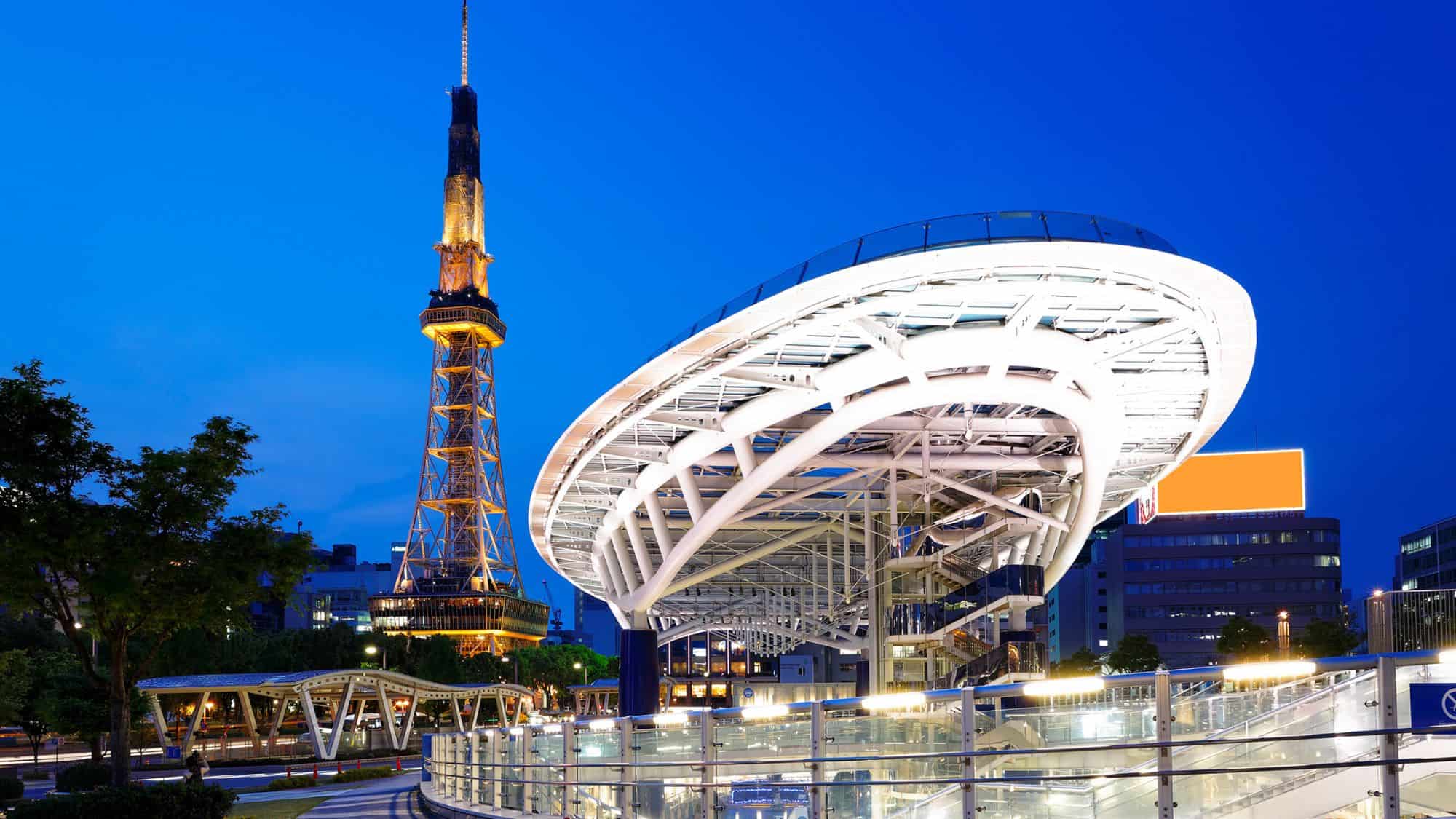 Nagoya’s skyline shines at night, showcasing the illuminated modern Oasis 21 structure alongside the towering Nagoya TV Tower.