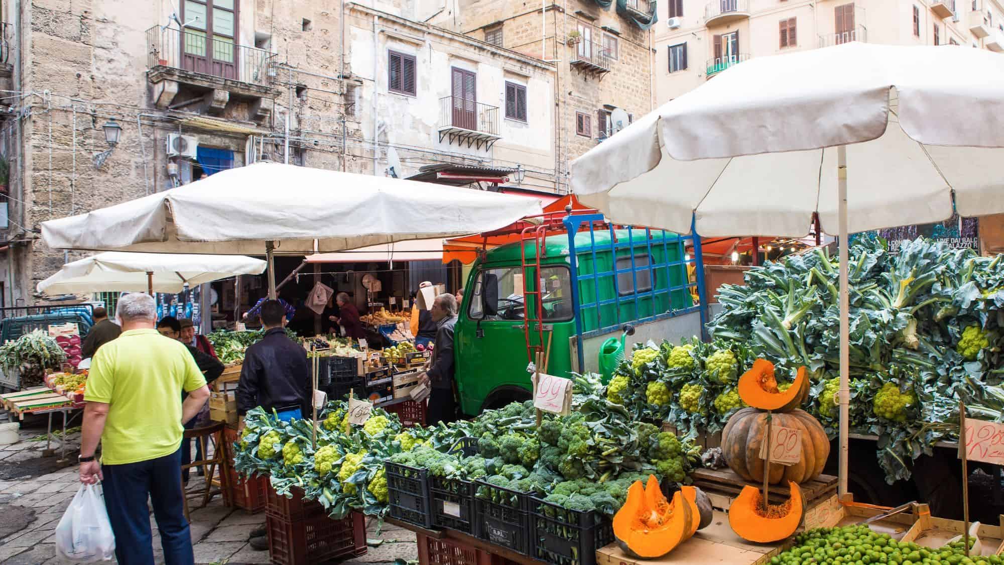PALERMO, ITALY - OCTOBER 23, 2014: Customers and sellers on Ballaro farmer's market on the streets of old Palermo city center, around Plaza Carmine. It is the oldest of Palermo's Arabic markets.