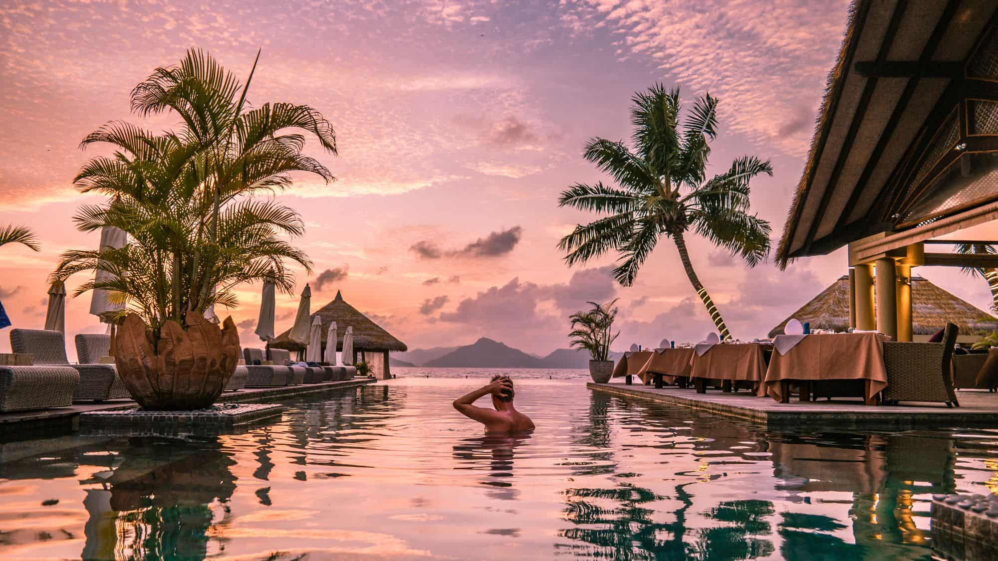 Luxury swimming pool in tropical resort, relaxing holidays in Seychelles islands. La Digue