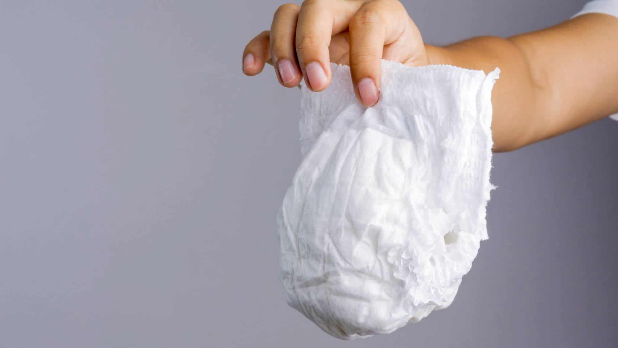 Used diaper improperly disposed of on an airplane seat, visibly unsanitary and inconsiderate, illustrating a peak travel etiquette violation.