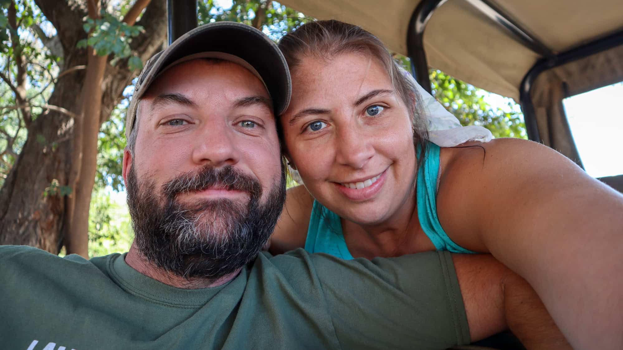 John and Jenny in a safari vehicle smiling at the camera in south africa