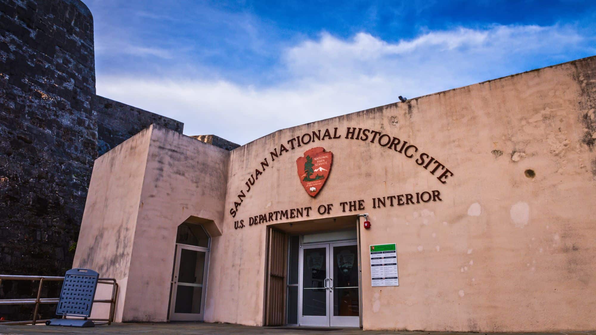 The entrance to San Juan National Historic Site with the National Park Service emblem on the wall.