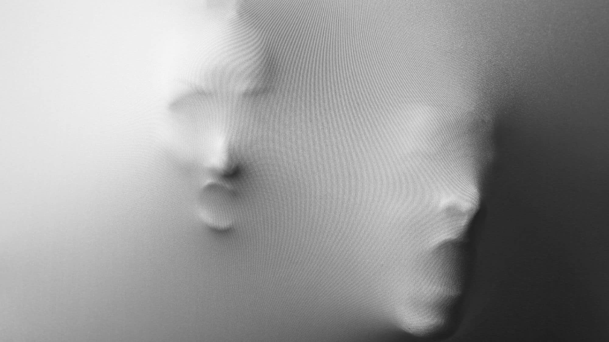 Distorted human faces press out from behind a translucent, textured surface, creating a haunting and abstract ghost-like appearance.